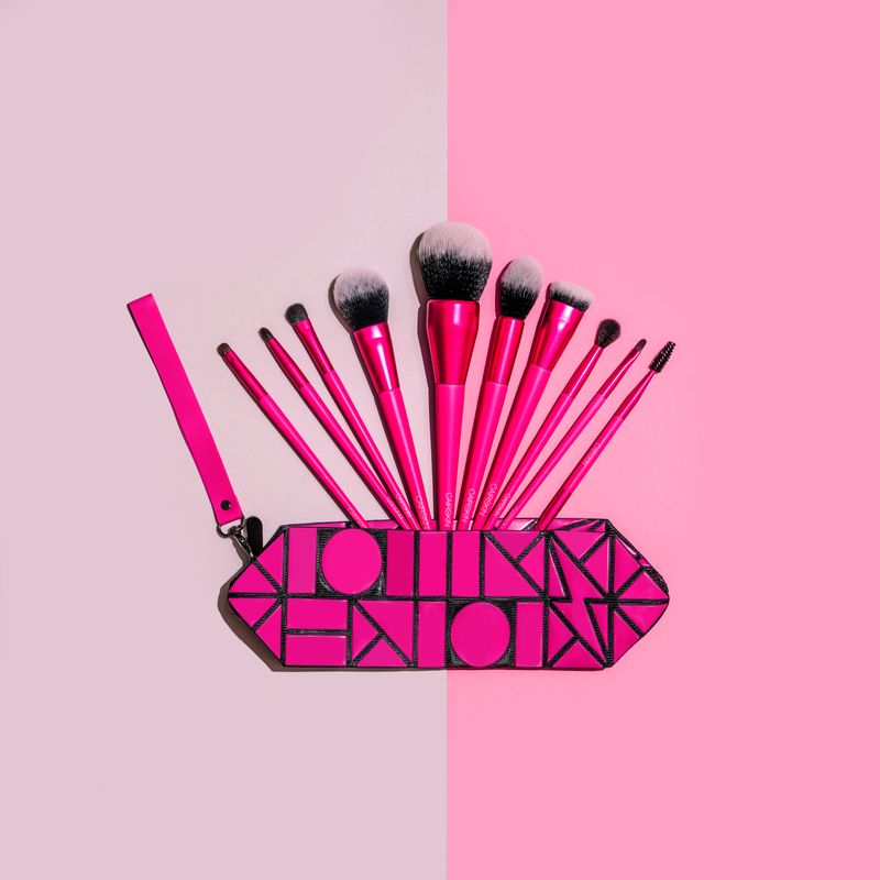 Fuchsia CAIRSKIN brushes in a geometric fuchsia pouch