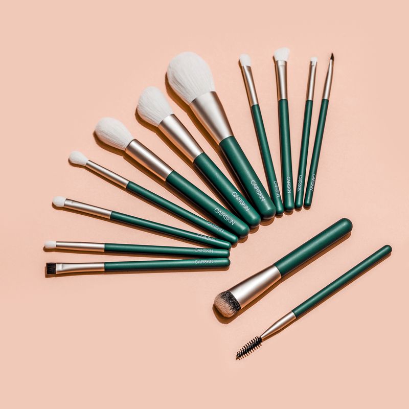 Emerald green CAIRSKIN brushes with champagne ferrules fanned out on peach